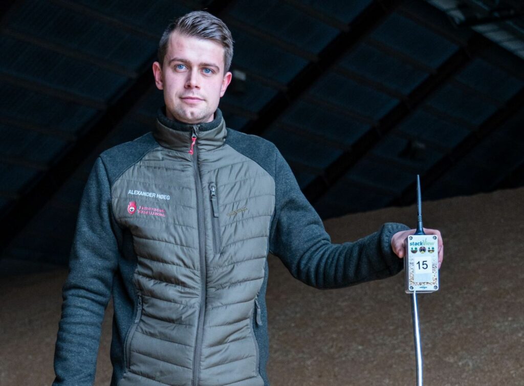 Man standing, holding StackView device